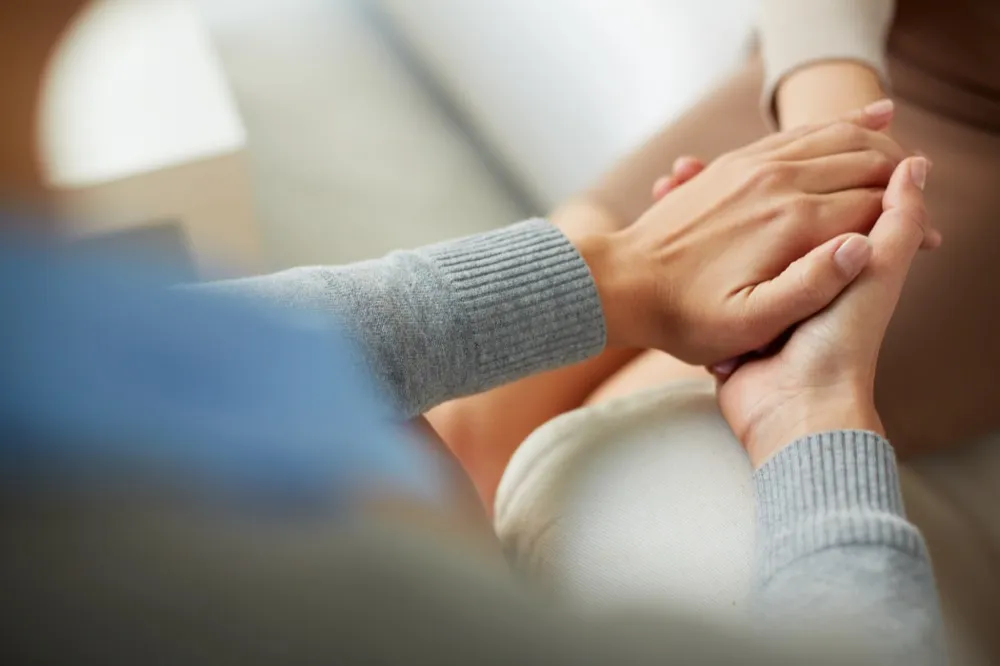 a therapist holding the patient's hand